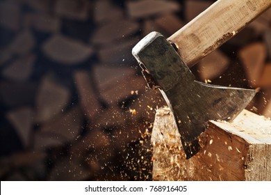 Chopping Wood With Axe - Closeup On Flying Wooden Chips On Dark Wood Stack Background, Copy Space