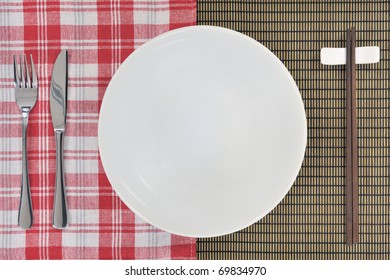 Chopsticks, Knife, Fork, Plate Showing Fusion Cooking Concept