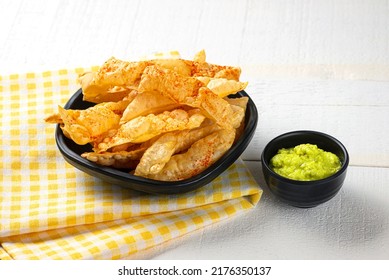 Chorafali. Indian chorafali crispy, crunchy and tasty gujarati traditional home made farsan served with green chutney or tea. serving in black dish with yellow cloth on white background.