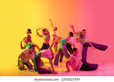 Choreography figures. School girls wearing white clothes dancing together on gradient background in neon light. Modern freestyle dance, contemporary art, movements, hobby, creative lifestyle concept - Powered by Shutterstock