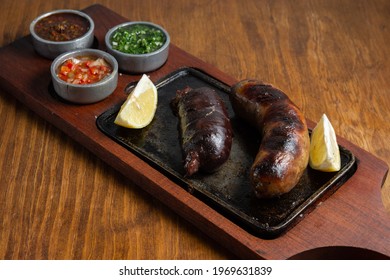chorizo ​​and blood sausage with sauce on table