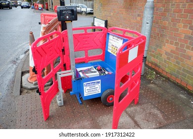 Chorleywood, Hertfordshire, England, UK - February 15th 2021: Fenton TM Traffic Management Specialists Temporary Traffic Light Power Unit And Push Button Control