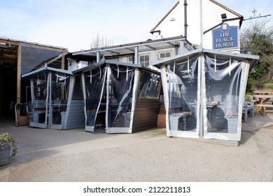 Chorleywood, Hertfordshire, England, UK - February 12th 2022: Wooden Cabins Used For Private Dining Outside Pub