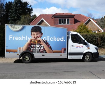 Chorleywood, Hertfordshire, England, UK - March 30th 2020: Tesco home delivery van supplying groceries to family during the Coronavirus (COVID-19) pandemic