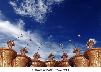 A chorus of trumpeter musician blowing their trumpet into the air to greet a new year celebration, against a blue sky with clouds.