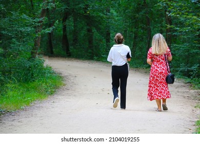 Chosen Focus. People Walking On The Wonderful Forest Path Among The Trees In Izmit Ormanya