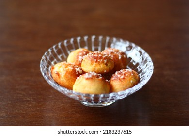 Chouquette in a beautiful glass bowl on the wooden table.
