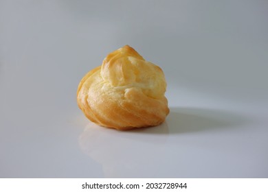 Choux Cream Cake Traditional French Dessert Displayed On Wooden Board. Tasty Creampuff Choux Isolated On White Background                