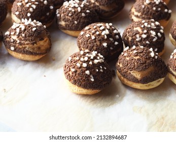 Choux pastry with chocolate craquelin and sugar nib topping