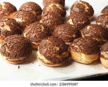 choux pastry with cracked chocolate crumble topping