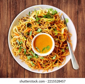 Chow Mein In A Plate With Chow Mein Sauce On A Wooden Tabletop, Chinese Noodles Chow Mein.