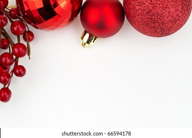 Chrismas Red Baubles And Red Berries On White Background