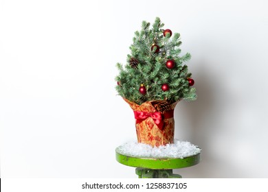 Chrismtas Tree With Red Ornaments On Vintage Industrial Stool