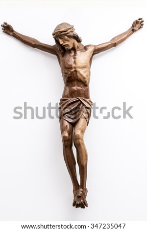 Christ crucified on the white wall of a modern Catholic church

