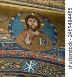 Christ Pantocrator. Mosaic on the triumphal arch in the Apse in the Basilica of Saint Clement (Basilica di San Clemente al Laterano) - Latin Catholic minor basilica. Rome, Italy.