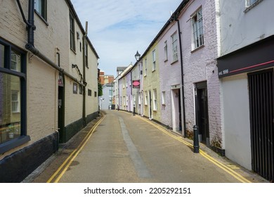 Christchurch, Dorset, England - 09.20.2022 - View Down Narrow Lane In English Town Of Christchurch. Back Road With Colorful Buildings. Street View 