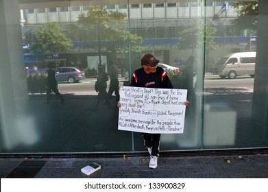 CHRISTCHURCH - FEB 29 2009:Muslim Man Holds Anti Semitic Sign Outside A Bank In Christchurch,New Zealand. 2008-2012 Global Recession Is Shaping Up To Be The Worst Post-World War II Great Recession.