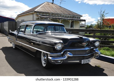 CHRISTCHURCH - MARCH 01: A Classic Cadillac Car Parked Outside An Old House In Christchurch, New Zealand On March 01 2009.In NZ There Are More Then 13,000 Vintage Classic Cars In Immaculate Condition