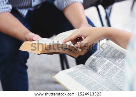 Christian bible god deliver devotional with hand friendship Holy Bible study  reading together in Sunday school
