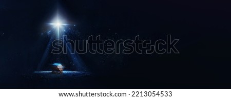 Christian Christmas concept. Birth of Jesus Christ. Wooden manger in dark blue night. Banner, copy space. Nativity scene. Jesus is reason for season. Salvation, Messiah, Emmanuel, God with us, hope
