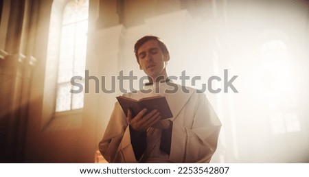 In Christian Church: Portrait of The Minister Praying, Reads From The Holy Book, The Bible, Gospel of Jesus Christ, Prophet. Priest Seeking Hope, Wisdom, Guidance in the Words of Lord