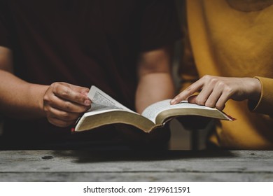 Christian couple or group reading study the bible together and pray at a home or Sunday school at church. concept studying the word of god. - Shutterstock ID 2199611591