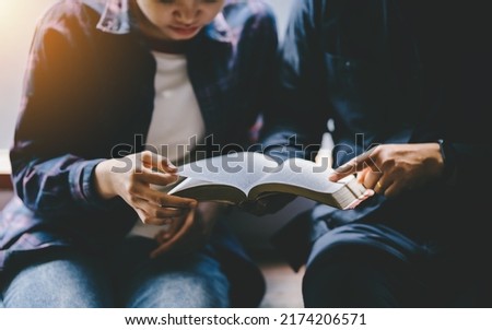 Christian couple or group reading study the bible together and pray at a home or Sunday school at church. concept studying the word of god.