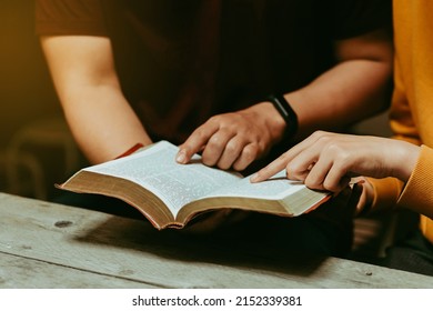 Christian couples read and study the Bible at home or in Sunday school. Sunday readings, spirituality, and religion Concept. - Shutterstock ID 2152339381
