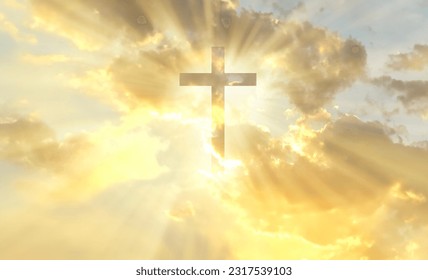 Christian cross appears bright in the gold sky background - Shutterstock ID 2317539103