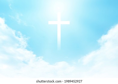 Christian Cross Appears Bright In The Sky Background And Soft Clouds. With The Light Shining As Love. Hope And Freedom Of God Jesus.