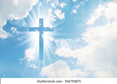 Christian cross appears bright in the sky background - Shutterstock ID 596793875
