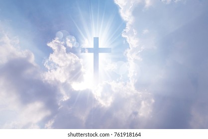 Christian cross appears bright in the sky background - Shutterstock ID 761918164