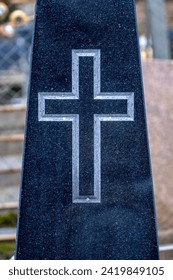 christian cross carved in granite tombstone