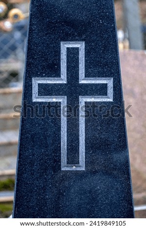 christian cross carved in granite tombstone