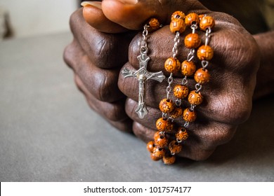 Christian Cross In Dark Brown Skin African Hand And Fist With The Cross Of Jesus Christ On Rosary