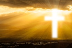 Christian Cross Glows Against The Rising Sun