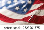 Christian cross necklace on American flag. For US Memorial Day, Veterans Day, USA memorial or military funeral. Representing honor and sacrifice of the armed forces from the United States of America.