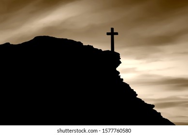 Christian Cross On The Edge Of A Cliff With A Dark Sky Background