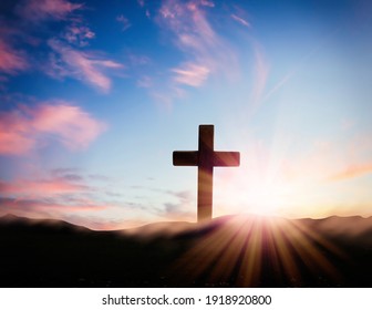 Christian cross on hill outdoors at sunrise. Resurrection of Jesus - Shutterstock ID 1918920800