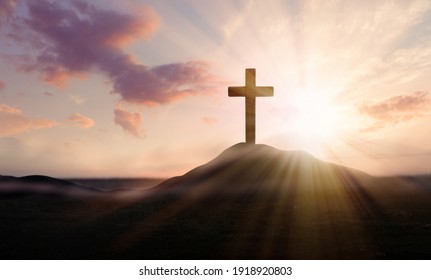 Christian cross on hill outdoors at sunrise. Resurrection of Jesus - Shutterstock ID 1918920803