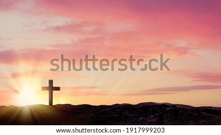 Christian cross on hill outdoors at sunrise. Resurrection of Jesus