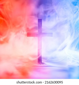 Christian cross surrounded by red and blue smoke symbolizing Heaven and Hell, good and evil, right and wrong, or other metaphor for moral choices. - Shutterstock ID 2162630095