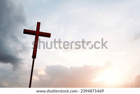 A christian cross under cloudy sky.