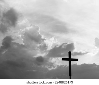 A christian cross under the dark sky.