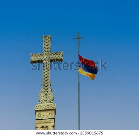 The Christian cross without a figure of Christ is the main religious symbol of Christianity next to Armenian flag on sky