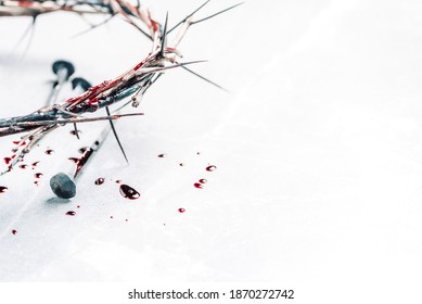 Christian crown of thorns with drops of blood, nails on grey background. Good Friday, Passion of Jesus Christ. Easter holiday. Copy space. Crucifixion, resurrection of Jesus Christ. Gospel, salvation.