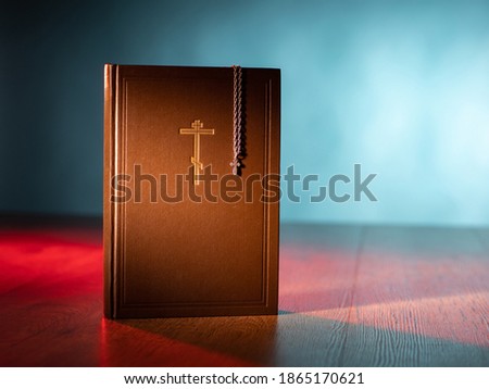 Christian faith. The direction of Christianity. Orthodox cross on the Bible. Faith in Jesus Christ. Communication with God. Symbol of Orthodoxy. Crucifix on a chain and a Holy Bible.