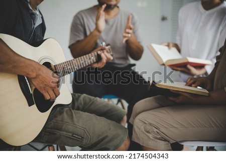  Christian family groups praying with Holy Bible. and play guitar to sing worship thanksgiving praise, reading Bible and sharing the gospel