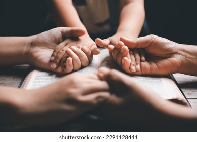 Christian family praying together concept. Child and mother worship God in home. Woman and boy hands praying to god with the bible begging for forgiveness and believe in goodness. - Shutterstock ID 2291128441