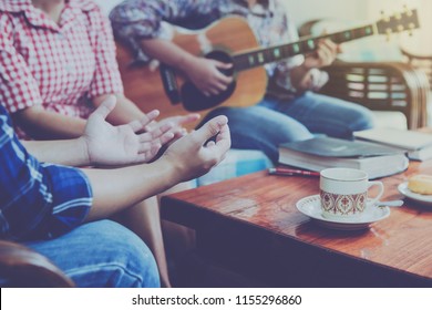 christian family worship God in home with coffee cup, Donut   and holy bible on wooden table 